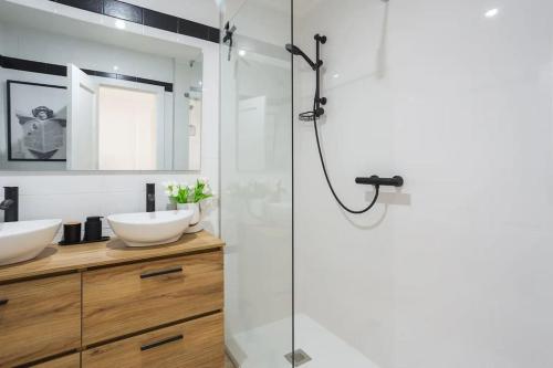 a bathroom with two sinks and a shower at Mediterranean Breeze Beach House in El Verger