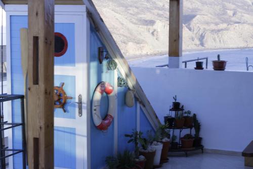 a blue door on a house with plants on it at Seaside House in Imsouane