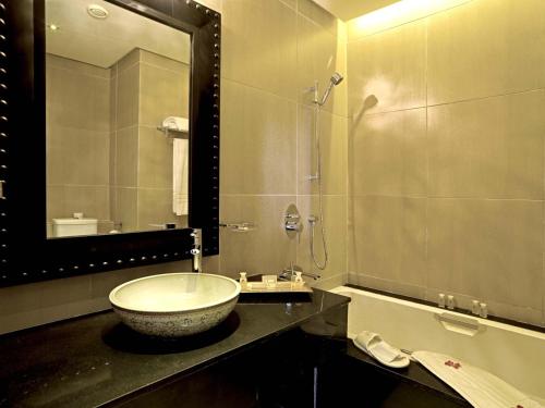 a bathroom with a sink and a mirror at Adam Park Marrakech Hotel & Spa in Marrakech