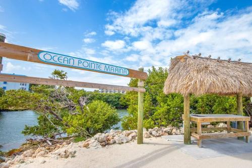 a sign that says ocean pointe market with a bench at Bright 2BR Condo with Breathtaking Ocean View in Tavernier
