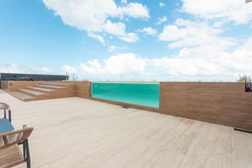 a swimming pool on the roof of a building at Musa del Carmen By Boutique Apartments MX in Playa del Carmen
