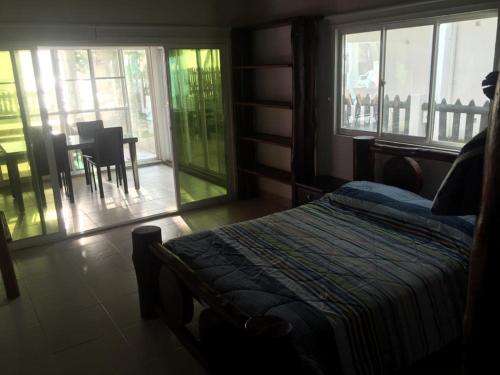 a bedroom with a bed and a table and chairs at Cabañas Privadas en Playas del Francés con Piscina in San Silvestre