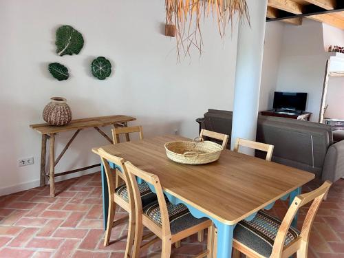 a dining room with a wooden table and chairs at Monte da Aferrada - CASAS DA VILA in Alpalhão