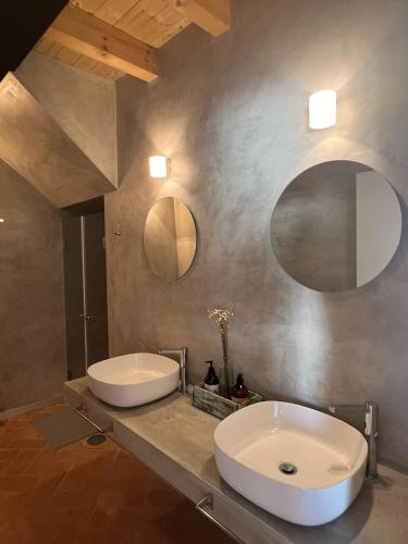 a bathroom with two sinks and a large mirror at Monte da Aferrada - CASAS DA VILA in Alpalhão