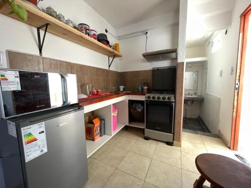 a small kitchen with a refrigerator and a table at Monoambiente Tilcara in Tilcara