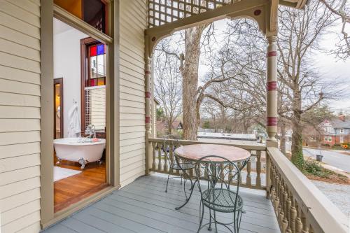 a porch with a table and a bath tub at Summit Street Inns in Winston-Salem