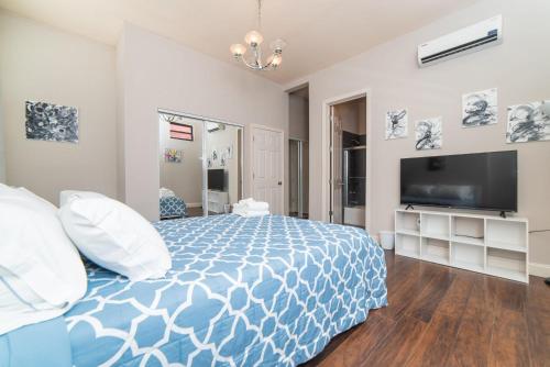 a bedroom with a bed and a flat screen tv at Unbeatable Location - Walkable Entertainment in Pittsburgh