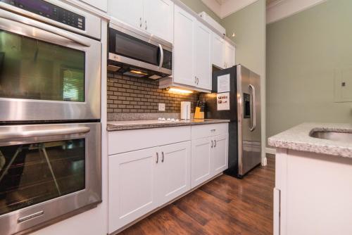 a kitchen with white cabinets and stainless steel appliances at Unbeatable Location - Walkable Entertainment in Pittsburgh