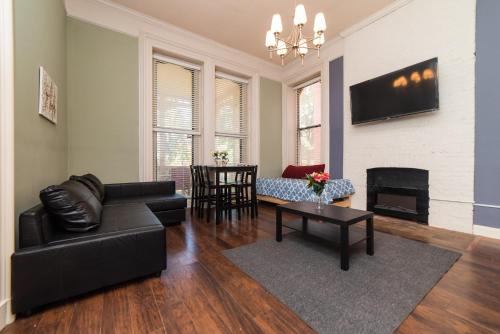 a living room with a couch and a fireplace at Unbeatable Location - Walkable Entertainment in Pittsburgh