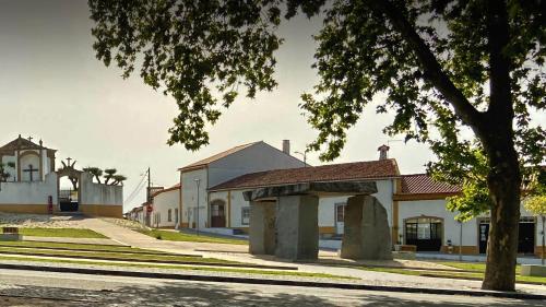 a street in a town with a building at Monte da Aferrada - CASAS DA VILA in Alpalhão