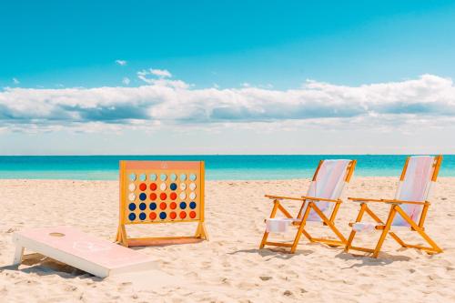 two beach chairs and a game on the beach at The Goodtime Hotel, Miami Beach a Tribute Portfolio Hotel in Miami Beach