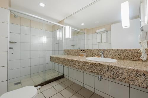 a bathroom with a sink and a mirror at Bourbon Hotel Fortaleza in Fortaleza