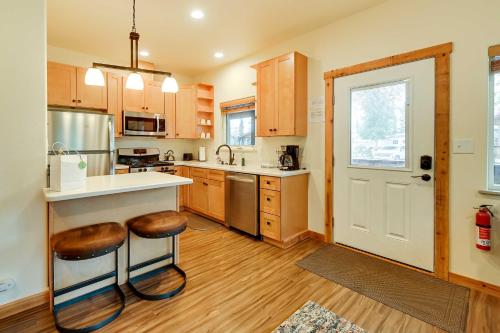 a kitchen with a counter and stools in it at Fishermans Cabin in Soldotna Near Kenai River! in Soldotna