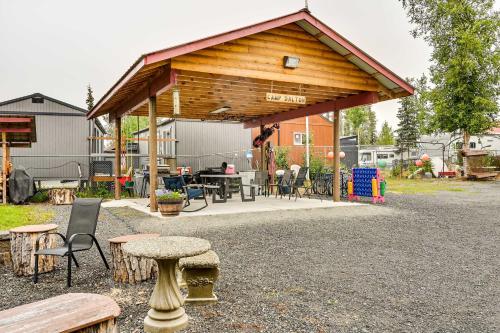 a pavilion with tables and chairs in a yard at Fishermans Cabin in Soldotna Near Kenai River! in Soldotna