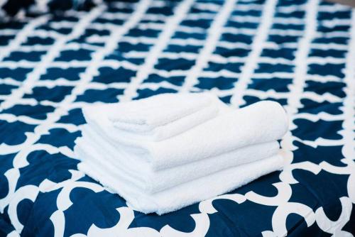 a stack of towels on a blue and white table at Central Location Suite - Walkable Entertainment in Pittsburgh