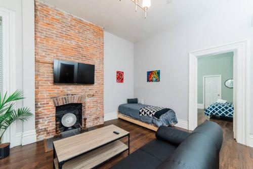 a living room with a couch and a fireplace at Business Suite - Walkable Entertainment in Pittsburgh