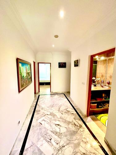 a large marble floor in a room with a bathroom at Elegant town house in la marsa plage in La Marsa