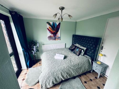 a bedroom with a bed and a painting on the wall at Home away from home in Swindon