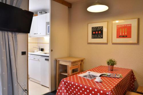 une petite pièce avec une table et une cuisine dans l'établissement Residence 3000 - Studio pour 4 Personnes 98, à Mâcot La Plagne