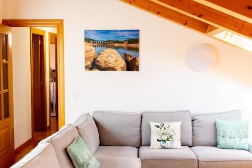 a living room with a couch and a painting on the wall at RENOVADO - Ático Plaza Herradores, céntrico y con Wifi in Soria