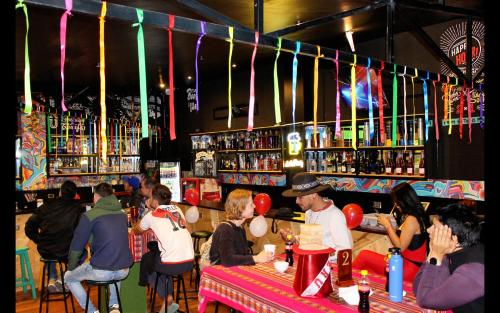 a group of people sitting at a bar at Magic Packer Hostel in Cusco