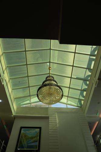 a glass ceiling with a chandelier hanging from it at HAMDAAN Hotel in Hargeysa
