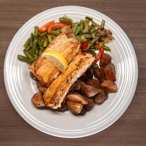 a plate of food with fish and potatoes and vegetables at Crowne Plaza Saint John Harbour View by IHG in Saint John