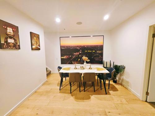 a dining room with a table and chairs and a large window at Eden - Fast & Furious 伊甸园 - 速度与激情 in Adelaide