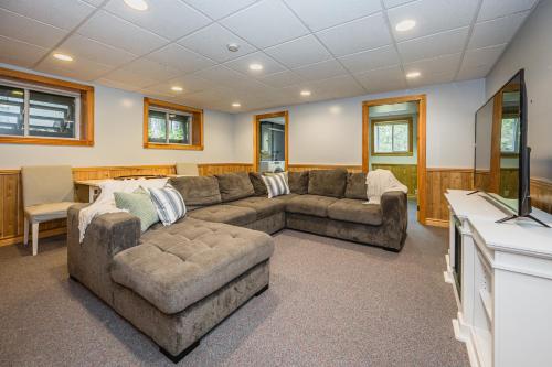 a living room with two couches and a television at Grotto Escape Unwind At Cameron Lakehouse in Tobermory