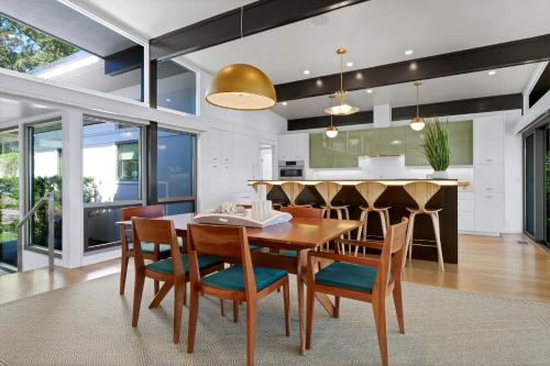 a kitchen and dining room with a wooden table and chairs at Masons View by Sea Scape Properties in Wrightsville Beach