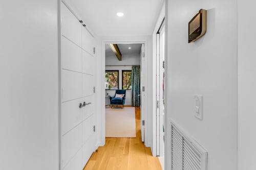 a hallway of a home with white walls and wood floors at Masons View by Sea Scape Properties in Wrightsville Beach