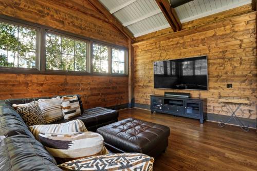 a living room with a couch and a flat screen tv at Masons View by Sea Scape Properties in Wrightsville Beach
