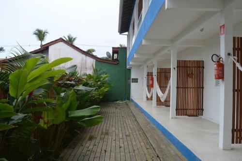 an empty hallway of a building with plants in it at Pousada JMedina Maresias in Maresias