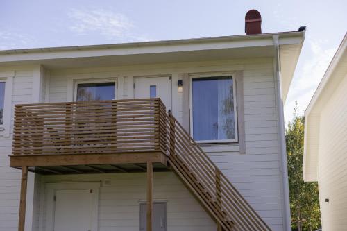 a wooden deck on the side of a house at Rådjursstigen 2A Vimmerby in Vimmerby