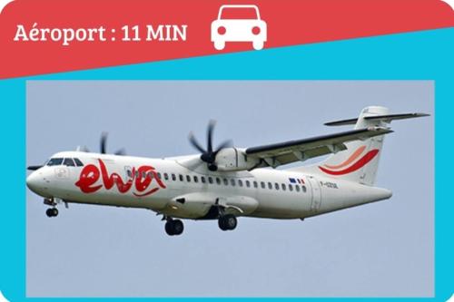 an airplane is flying in the sky at La VILLA BORAHA 300m2 PROPRIÉTÉ ENTIERE en bord de plage PISCINE PRIVEE Cuisine TV Wifi in Sainte Marie