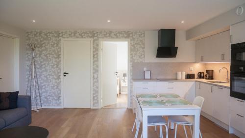 a kitchen and living room with a table and chairs at Rådjursstigen 2A Vimmerby in Vimmerby
