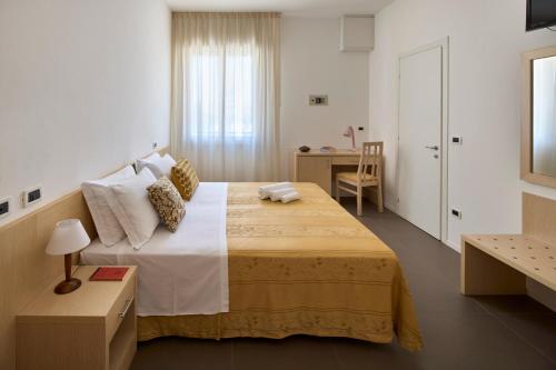 Postel nebo postele na pokoji v ubytování Hotel Dolores
