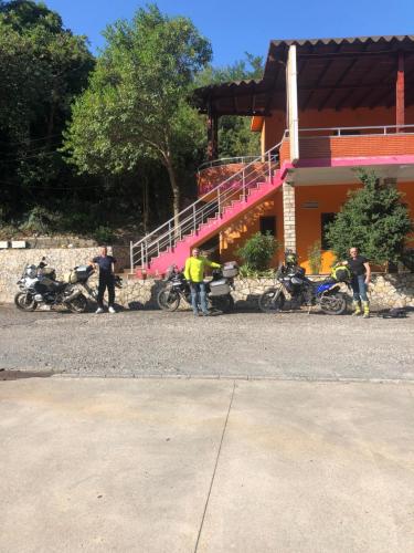 a group of motorcycles parked in front of a building at Hotel Xhej in Rubik