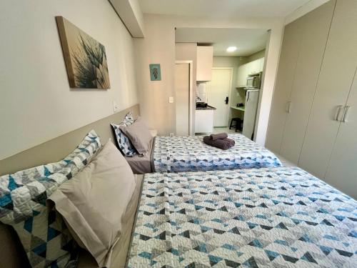 En eller flere senge i et værelse på Studio Iguatemi Ribeirão Preto