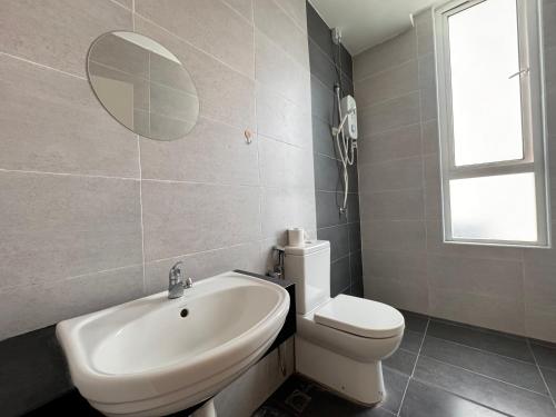 a bathroom with a sink and a toilet and a mirror at Ipoh D Festivo Suites 6-10pax 10mins to Sunway Tambun by IWH in Ipoh