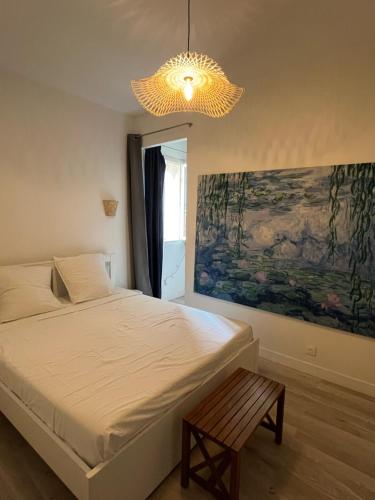 a bedroom with a bed and a chandelier at Escapade marseillaise in Marseille