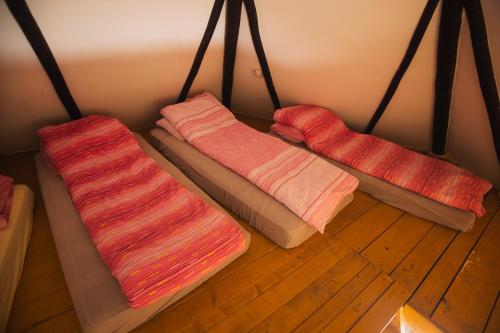 three cushions sitting on the floor in a room at GRAB ethno village and camp in Šćepan-Polje