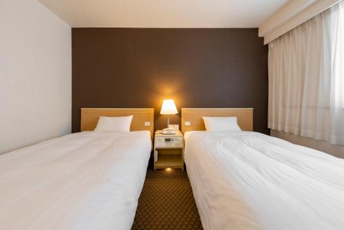 Кровать или кровати в номере Okayama Washington Hotel Plaza