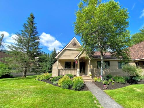 a house with a green lawn and trees at F3 Well appointed Townhome a short walk to the Mount Washington Hotel 1 minute to ski area in Bretton Woods