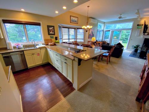 a large kitchen and living room with a large island at F3 Well appointed Townhome a short walk to the Mount Washington Hotel 1 minute to ski area in Bretton Woods