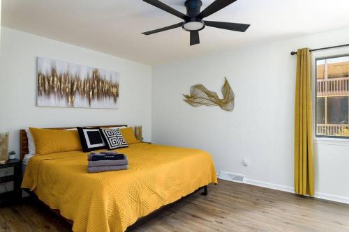 a bedroom with a bed with a ceiling fan at Grey Sapphire Hideaway - 2BR 2BA w Arcade & Pool in Winston-Salem