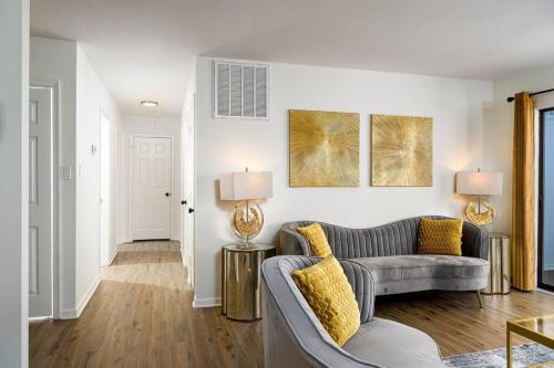a living room with a couch and two lamps at Grey Sapphire Hideaway - 2BR 2BA w Arcade & Pool in Winston-Salem