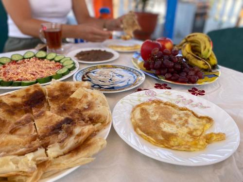 a table topped with plates of food and fruit at La Veranda 陽台 in Aswan