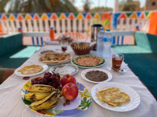 a table with plates of food and fruit on it at La Veranda 陽台 in Aswan