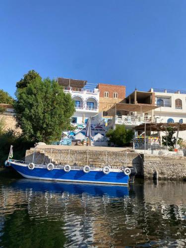 a blue boat is docked in the water at La Veranda 陽台 in Aswan